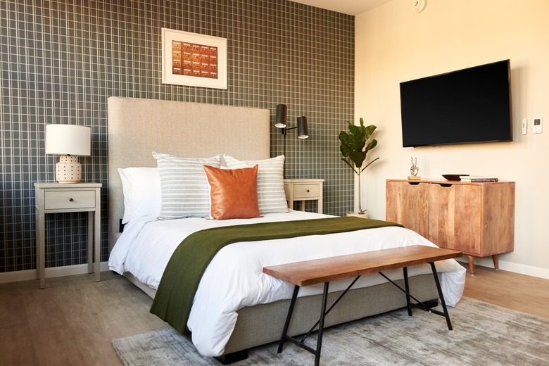 Eclectic bedroom with upholstered headboard